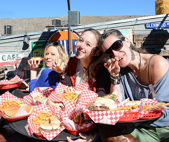 Women enjoying food on the rooftop patio of No Name Saloon & Grill